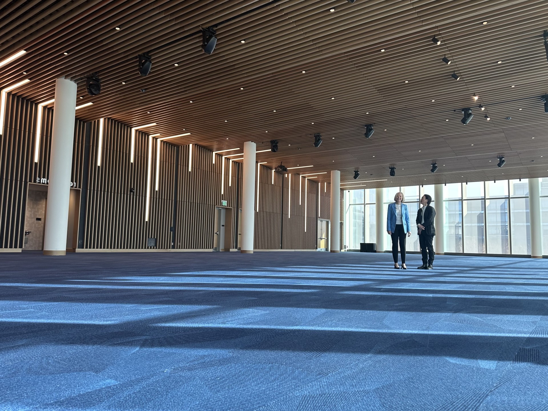 OPA President Joan Squires and Architect Stephen Chu inside the Tenaska Center's event hall.