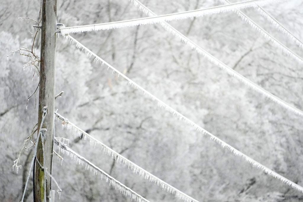 Ice covers lines on a utility pole during a winter storm Sunday, Jan. 25, 2026, in Nashville, Tenn.