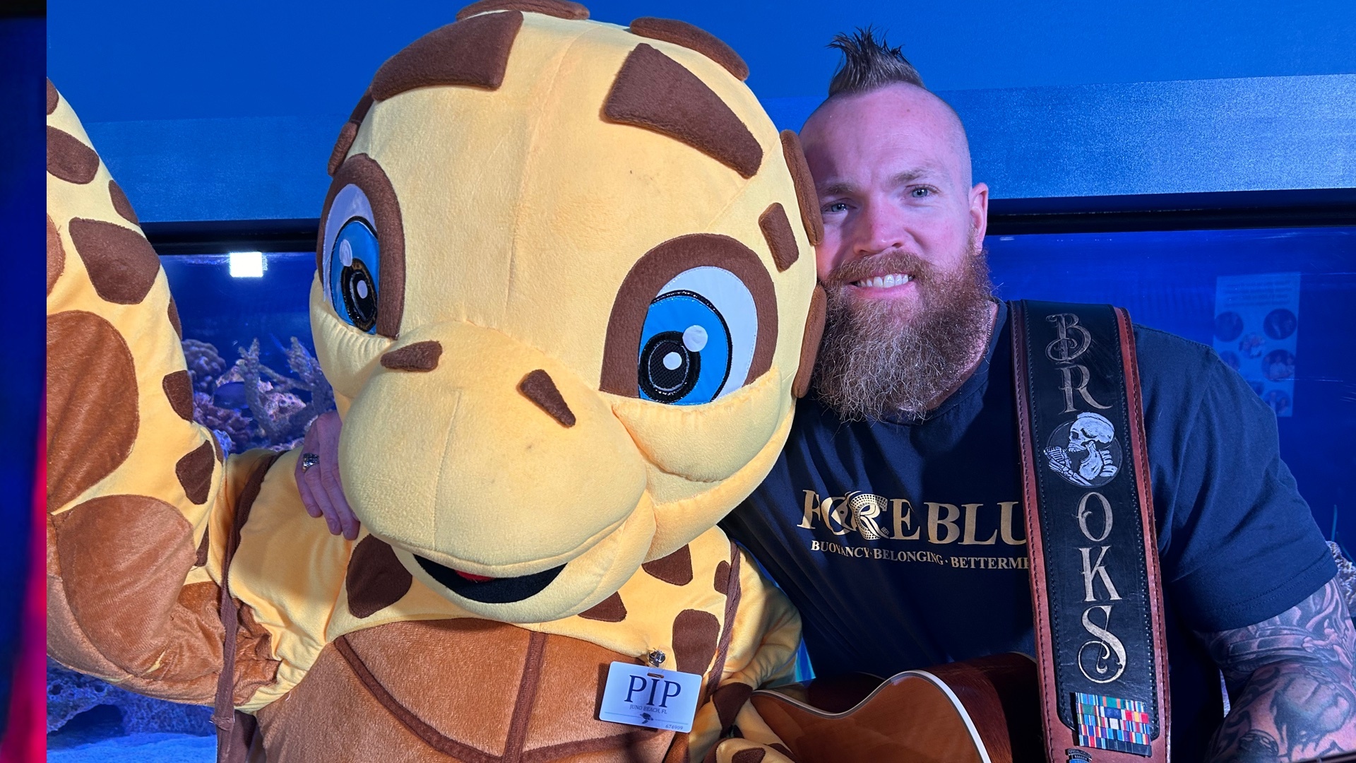 Pip Loggerhead Marinelife mascot with singer Brooks Herring .jpg