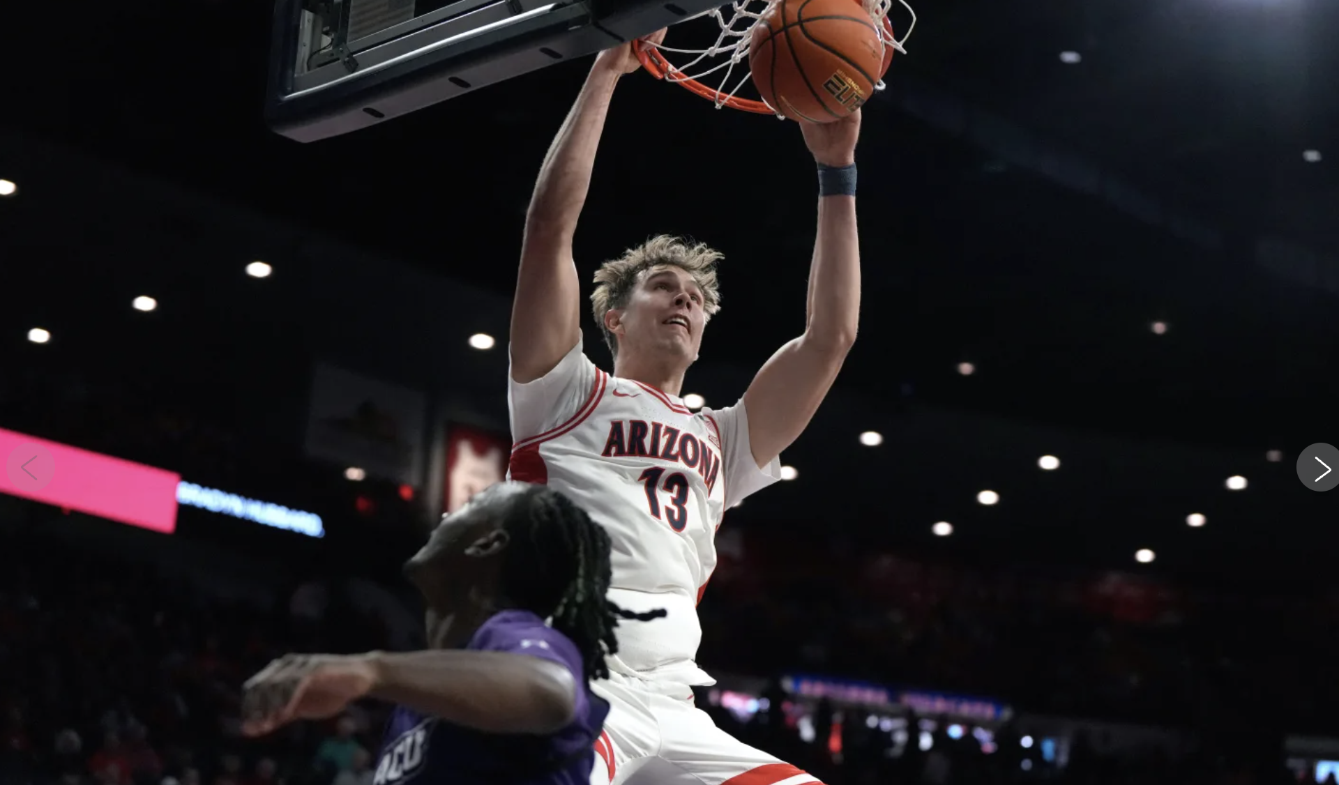 Mo Krivas slam dunks the basketball 