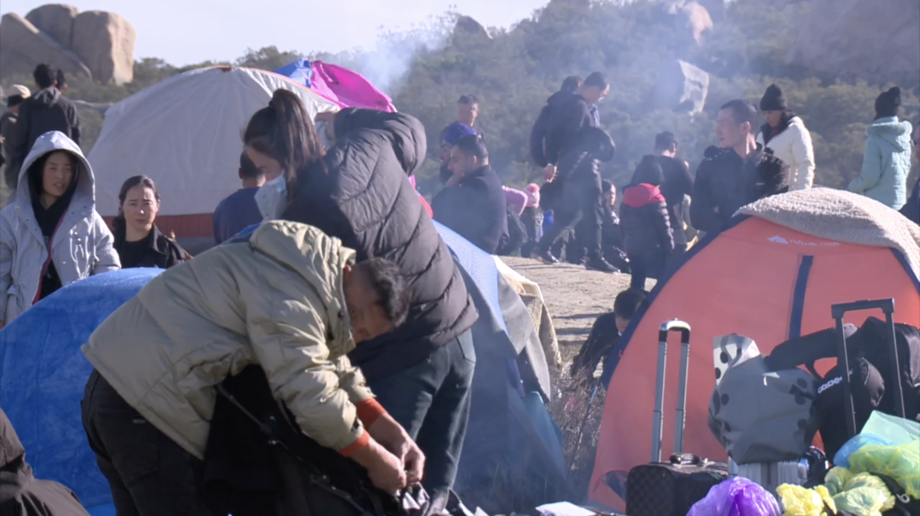 Migrants in Jacumba shelter against rain with make-shift tents