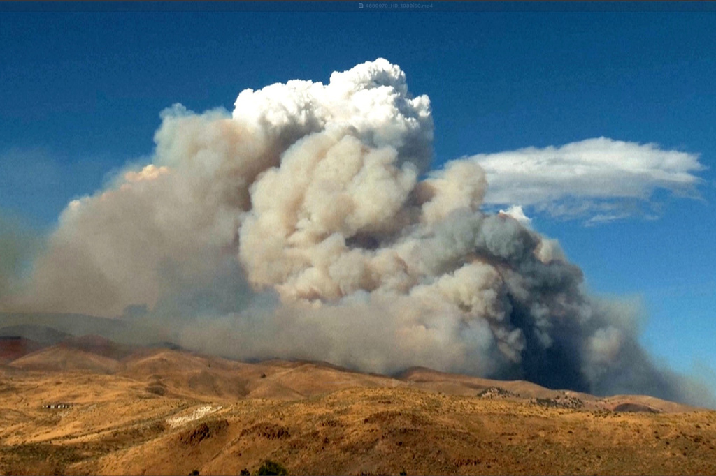 This image taken from video shows plumes of smoke rising from active wildfires Saturday, Aug. 22, 2026, in Reno, Nevada.