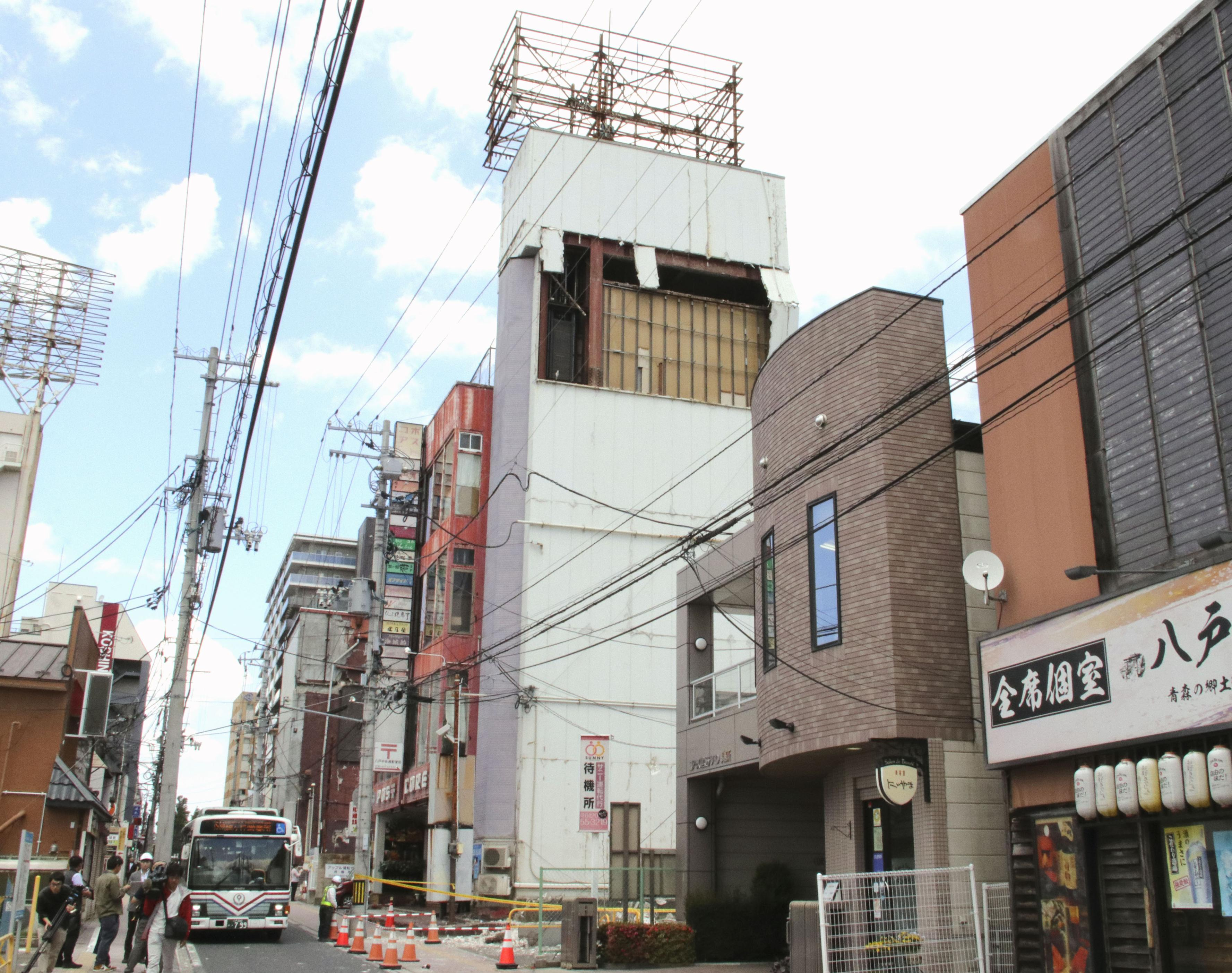 The wall of a building is seen partly damaged following an earthquake in Hachinohe, Aomori prefecture northern Japan, Thursday, June 25, 2026.