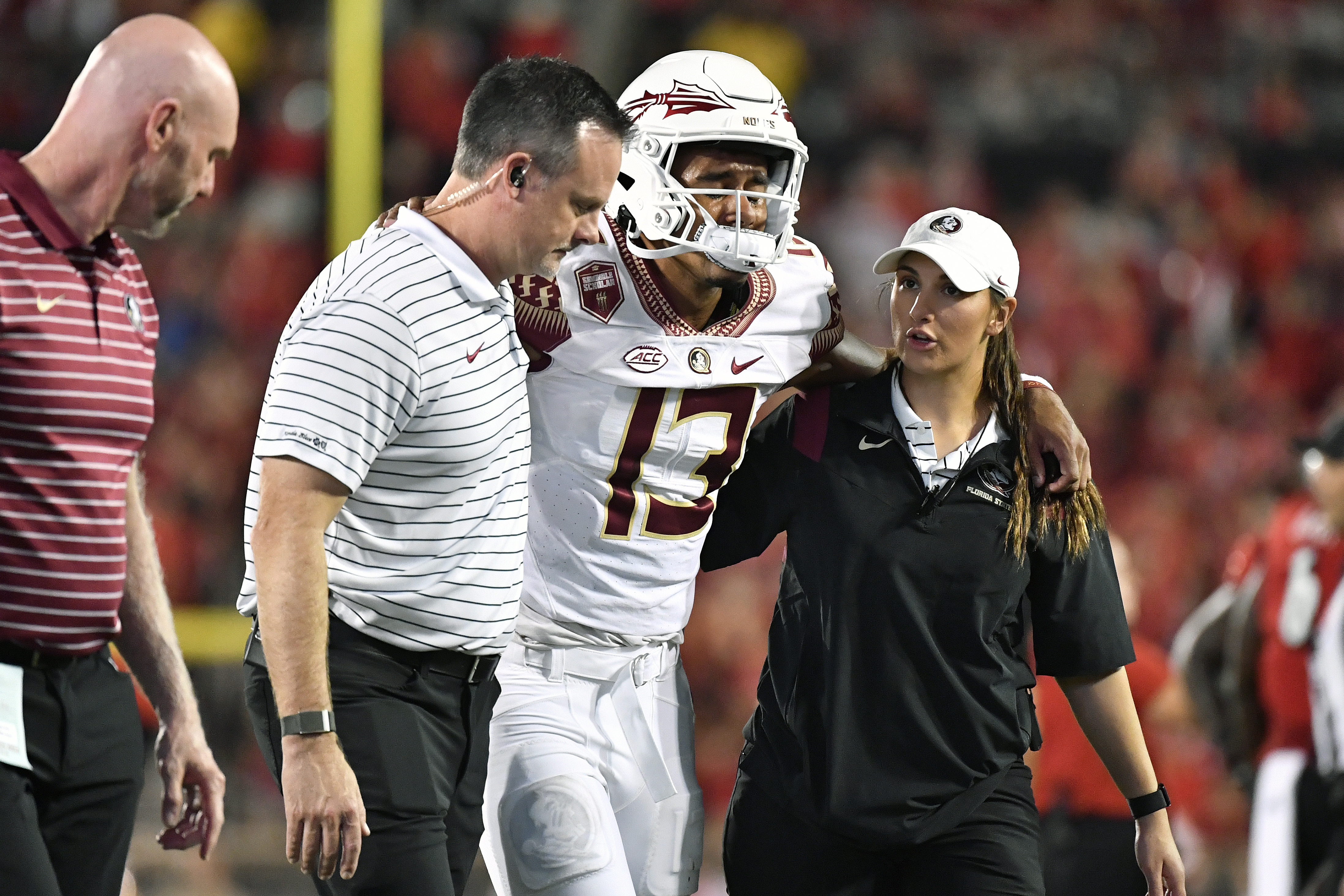 Florida State Seminoles QB Jordan Travis helped off field at Louisville Cardinals, Sept. 16, 2022