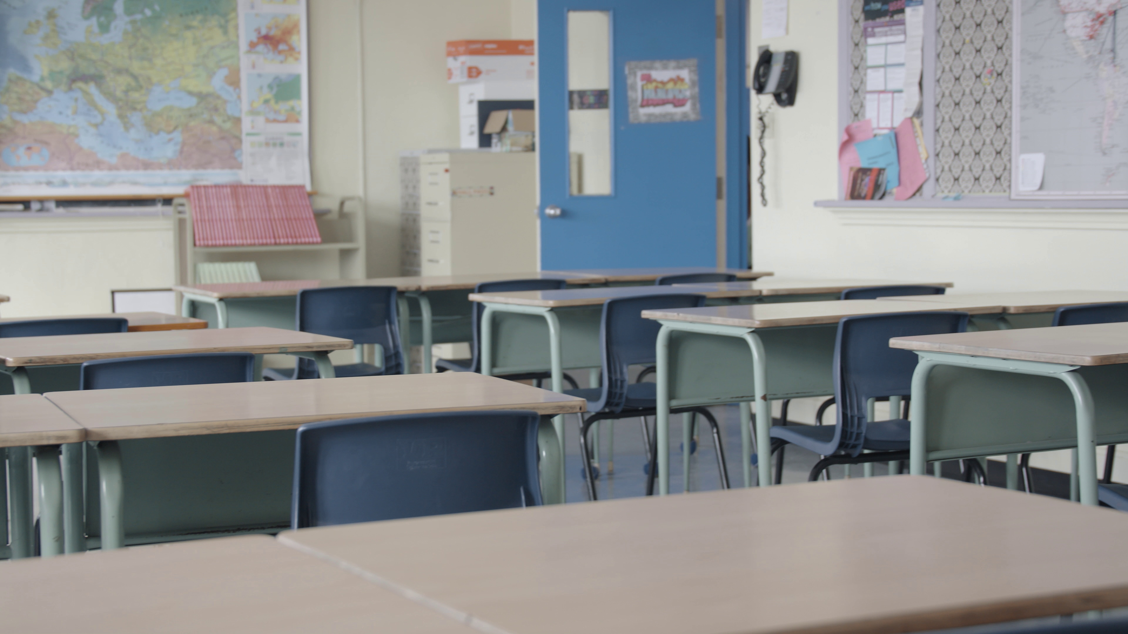empty-classroom-full-of-desks-in-a-high-school-SBI-351043404.jpg
