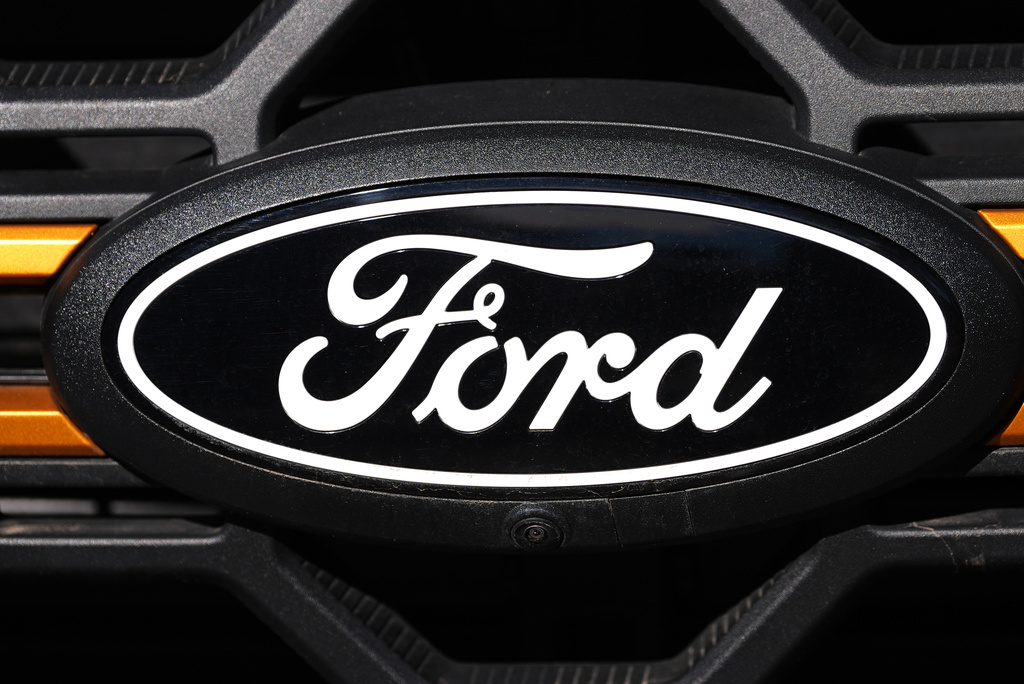 FILE - A Ford logo is seen on the grille of an unsold vehicle at a Ford dealership, Nov. 2, 2025, in Littleton, Colo. (AP Photo/David Zalubowski, File)