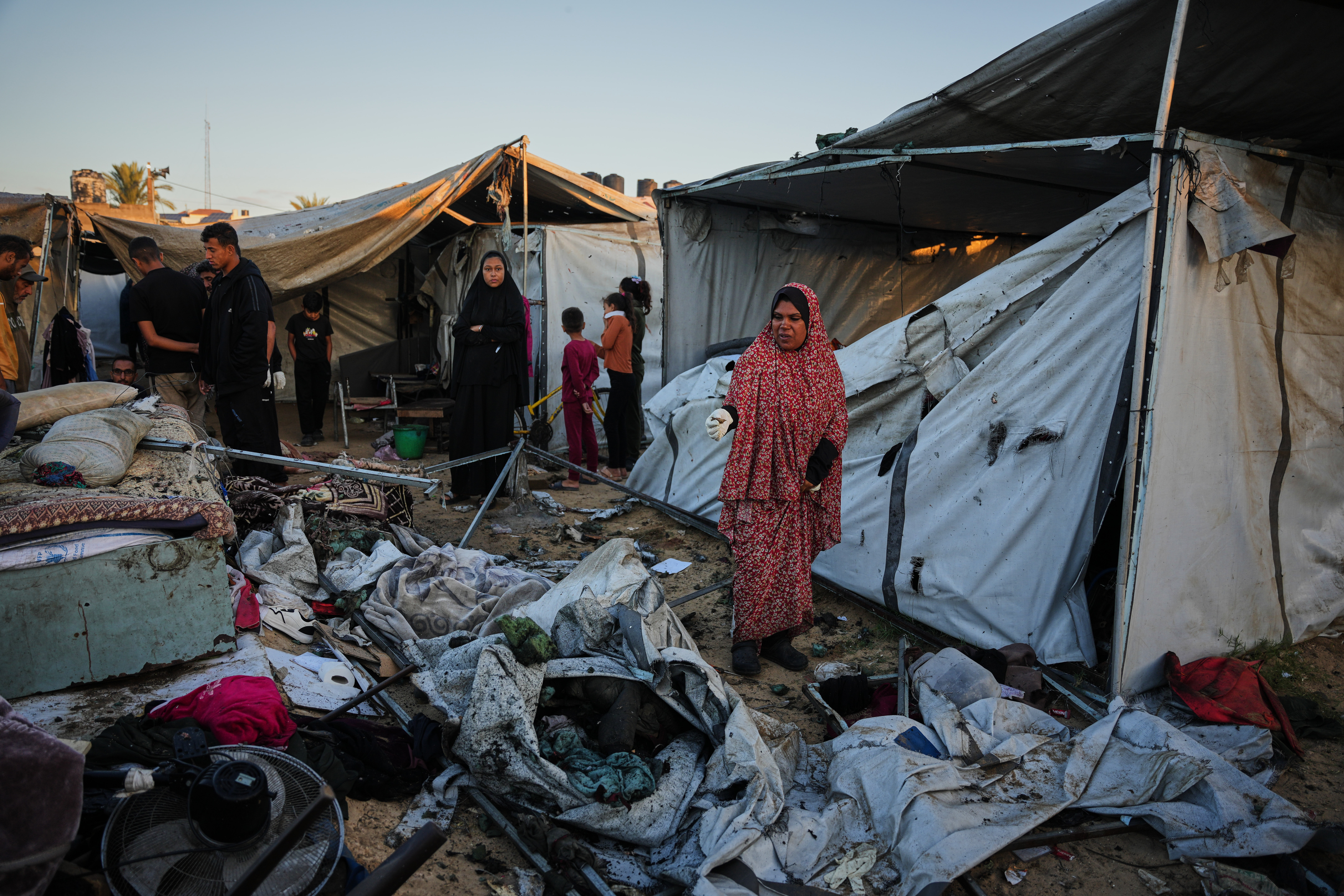 Displaced Palestinians inspect the damage after an Israeli army strike on their tent camp in Deir al-Balah, Gaza Strip, Wednesday, Oct. 29, 2025.