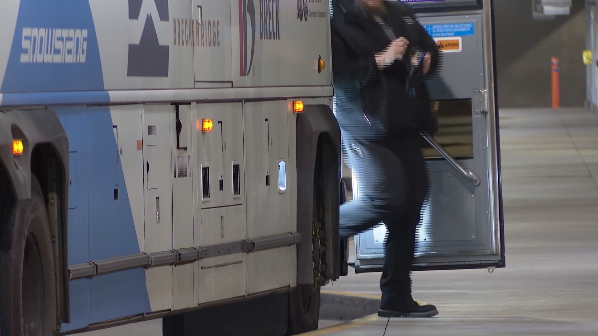 Man stepping off public transportation bus for passengers