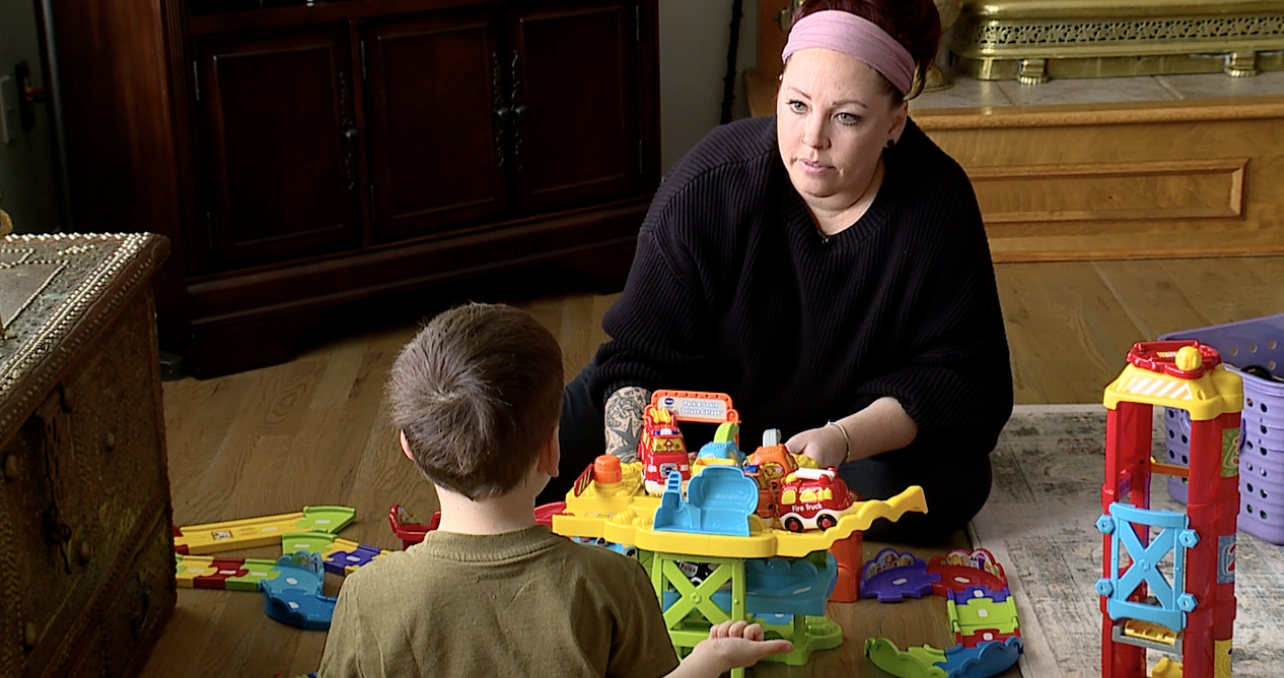 Paige Barrows plays with her son