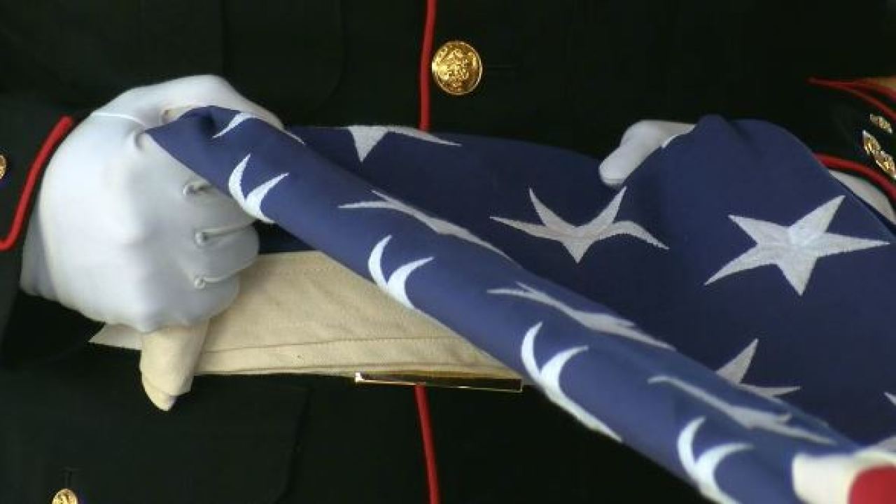 Soldier folding American flag