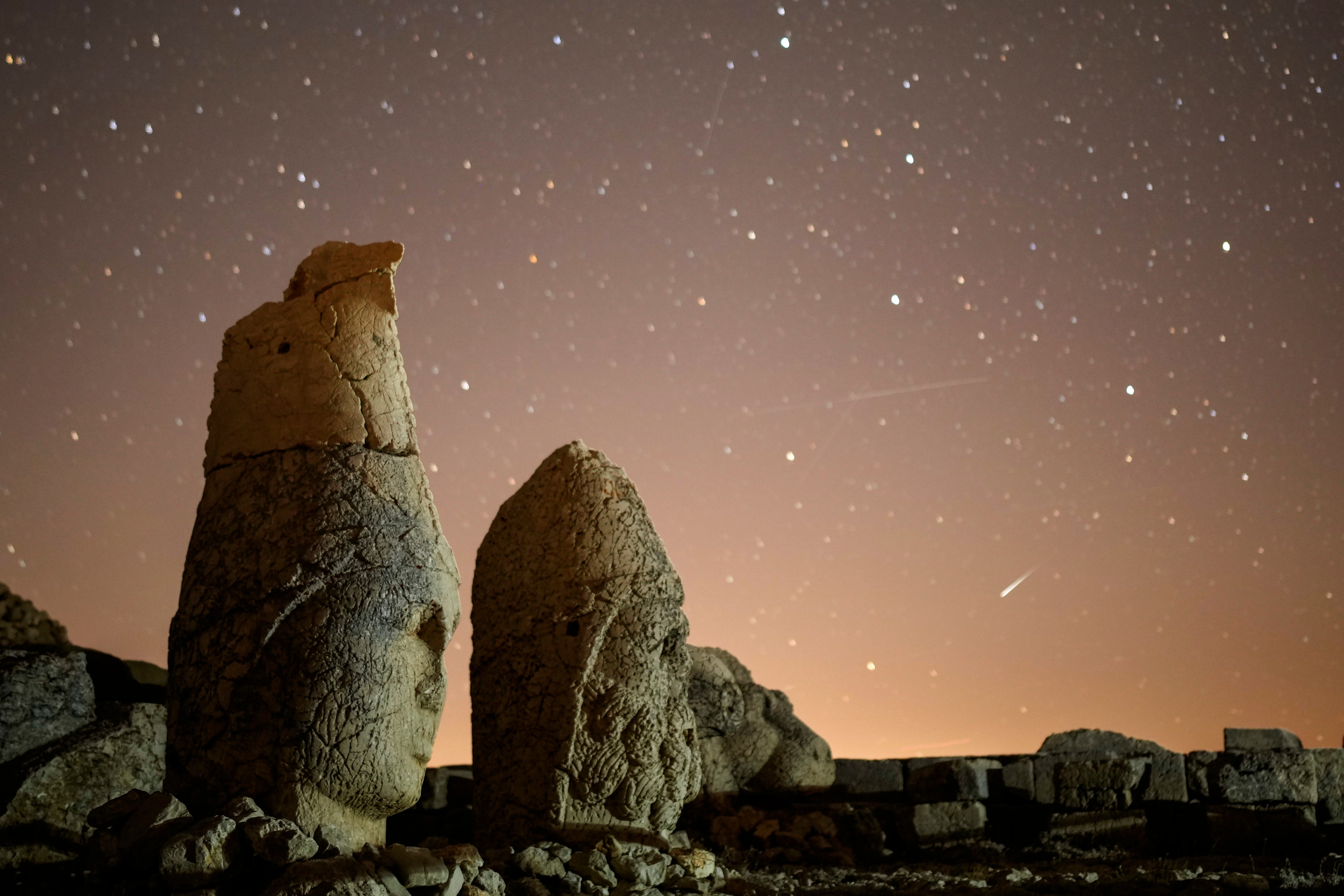 FILE - Ancient statues are seen during the Perseid meteor shower atop Mount Nemrut in southeastern Turkey, Sunday, Aug.11, 2024.