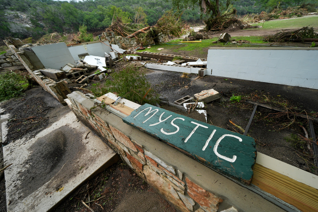 A Camp Mystic sign is seen near the entrance to the establishment along the banks of the Guadalupe River in Hunt, Texas, July 5, 2025, after a flash flood swept through the area. 