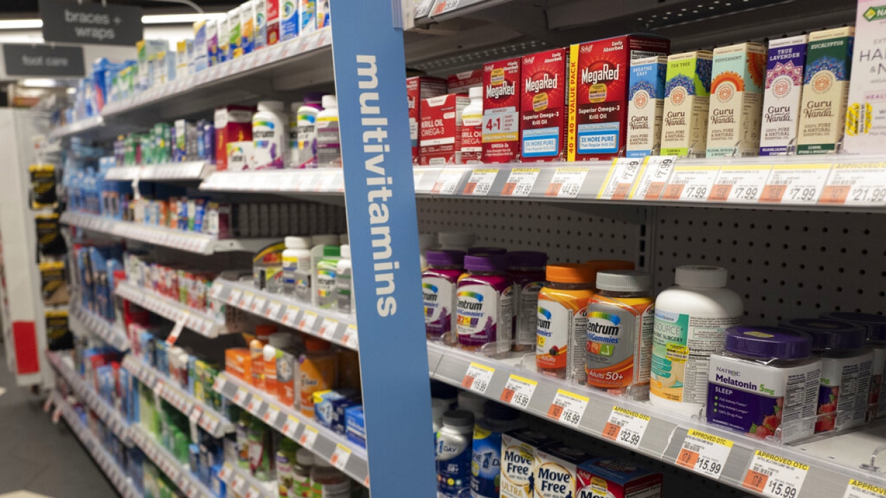 Vitamins are displayed in a pharmacy.