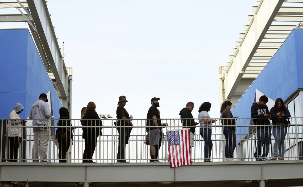 Voters wait in a long line at a polling place.