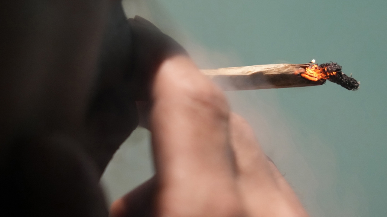 A tourist smokes cannabis at a Dutch passion shop.