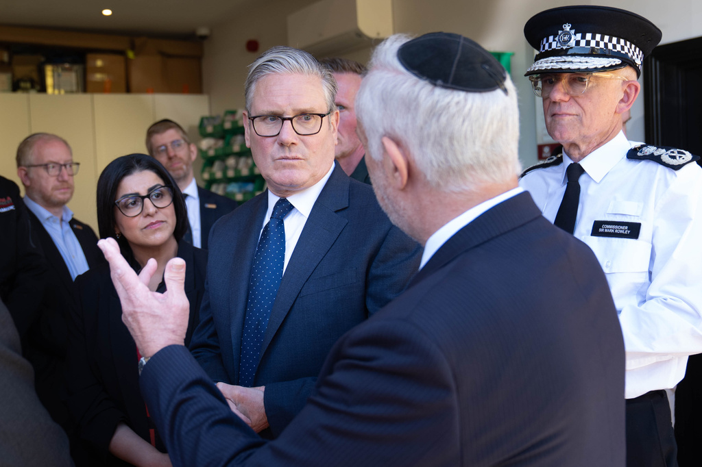 Britain's Prime Minister Keir Starmer, center, Metropolitan Police Commissioner Mark Rowley, right, and Home Secretary Shabana Mahmood, 2nd left, speak with members of the Jewish community during a visit to Golders Green, north west London, Thursday April 30, 2026, following an attack on Wednesday in which two men were stabbed.
