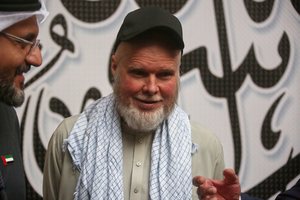 American Dennis Coyle smiles after being released by Afghanistan's Taliban authorities, who had held him for over a year, before boarding a plane at the airport in Kabul, Afghanistan, Tuesday, March 24, 2026.
