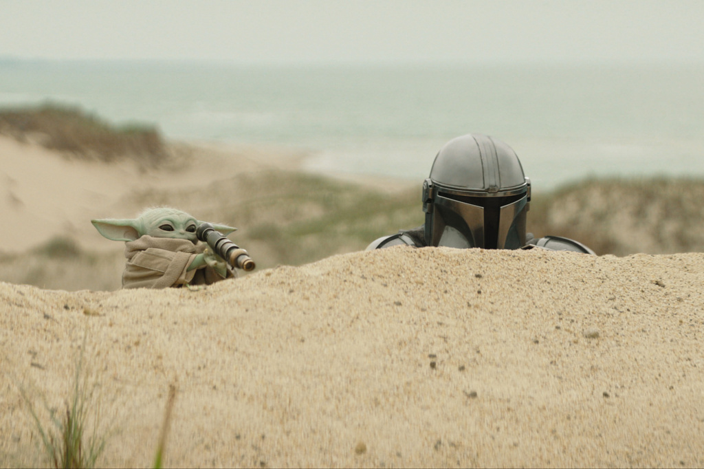 This image released by Disney shows The Mandalorian, portrayed by Pedro Pascal, right, and Grogu in a scene from Lucasfilm's "Star Wars: The Mandalorian and Grogu."