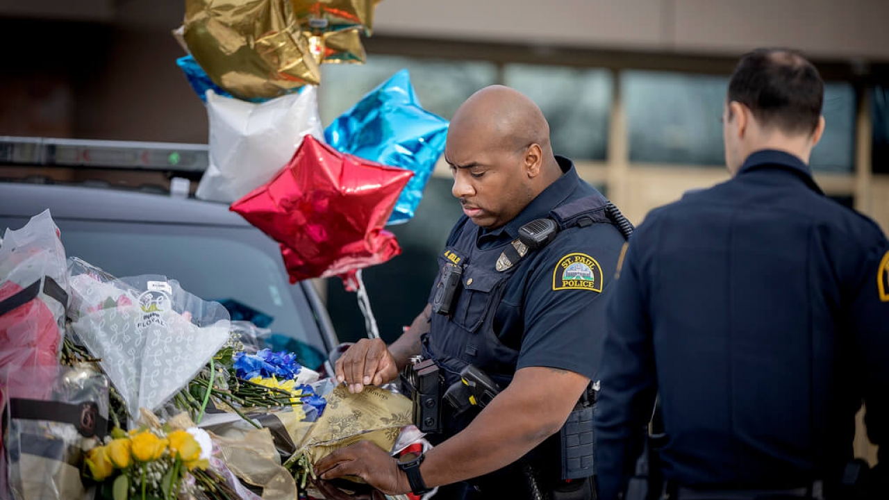 Police at a memorial to first responders killed in Minnesota.