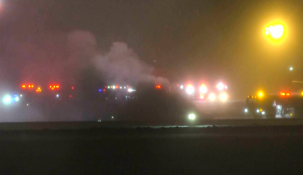 This image taken from video provided by WABI television, emergency cervices work on a scene of the Bombardier Challenger 600 crash at the Bangor Airport in Maine, late Sunday, Jan. 25, 2026.