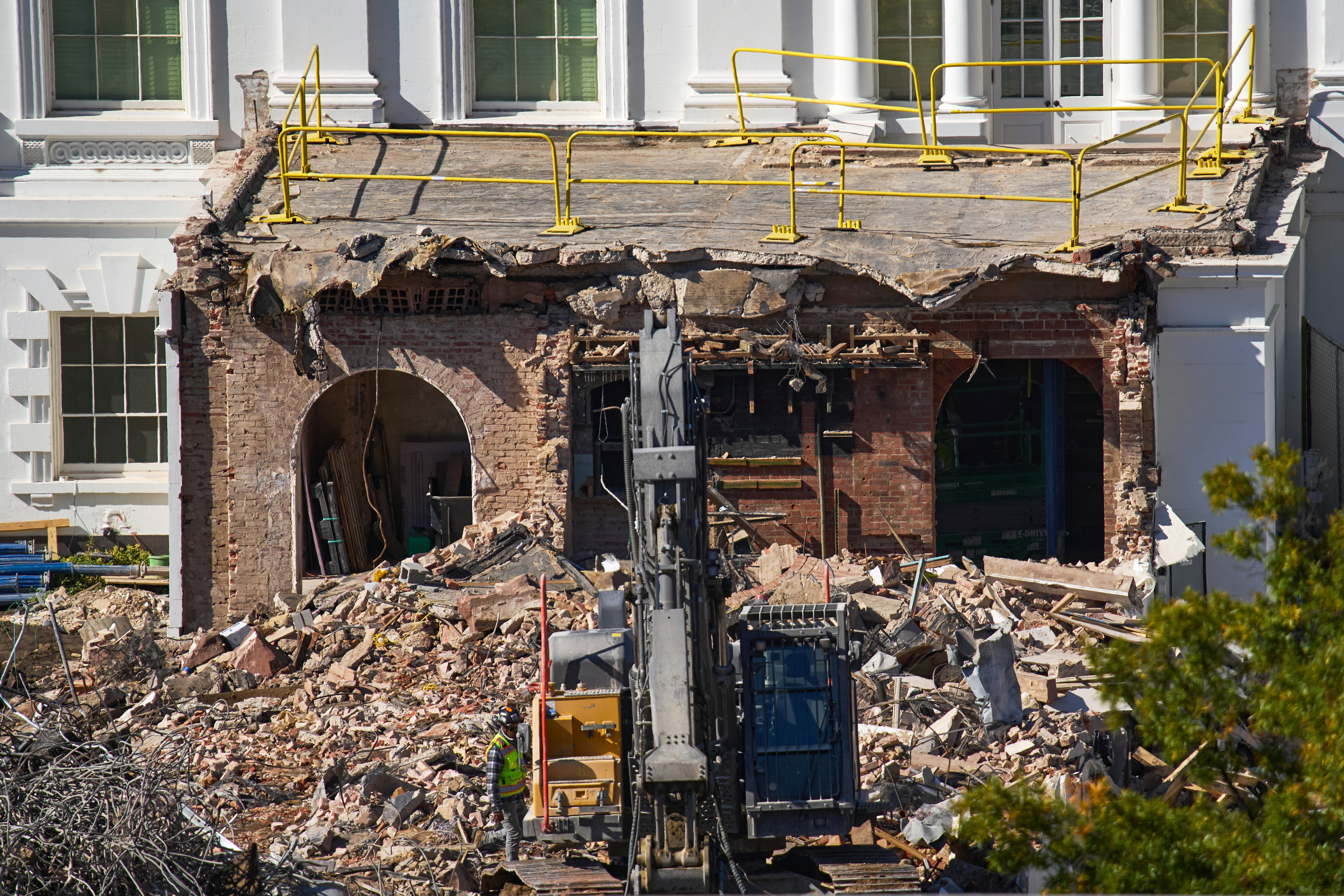 A worker walks among debris from a largely demolished part of the East Wing of the White House, Oct. 23, 2025, in Washington, before construction of a new ballroom.