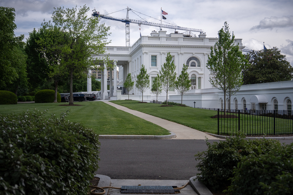 A crane being used to construct the new White House ballroom is seen above the White House, Sunday, April 19, 2026, in Washington.