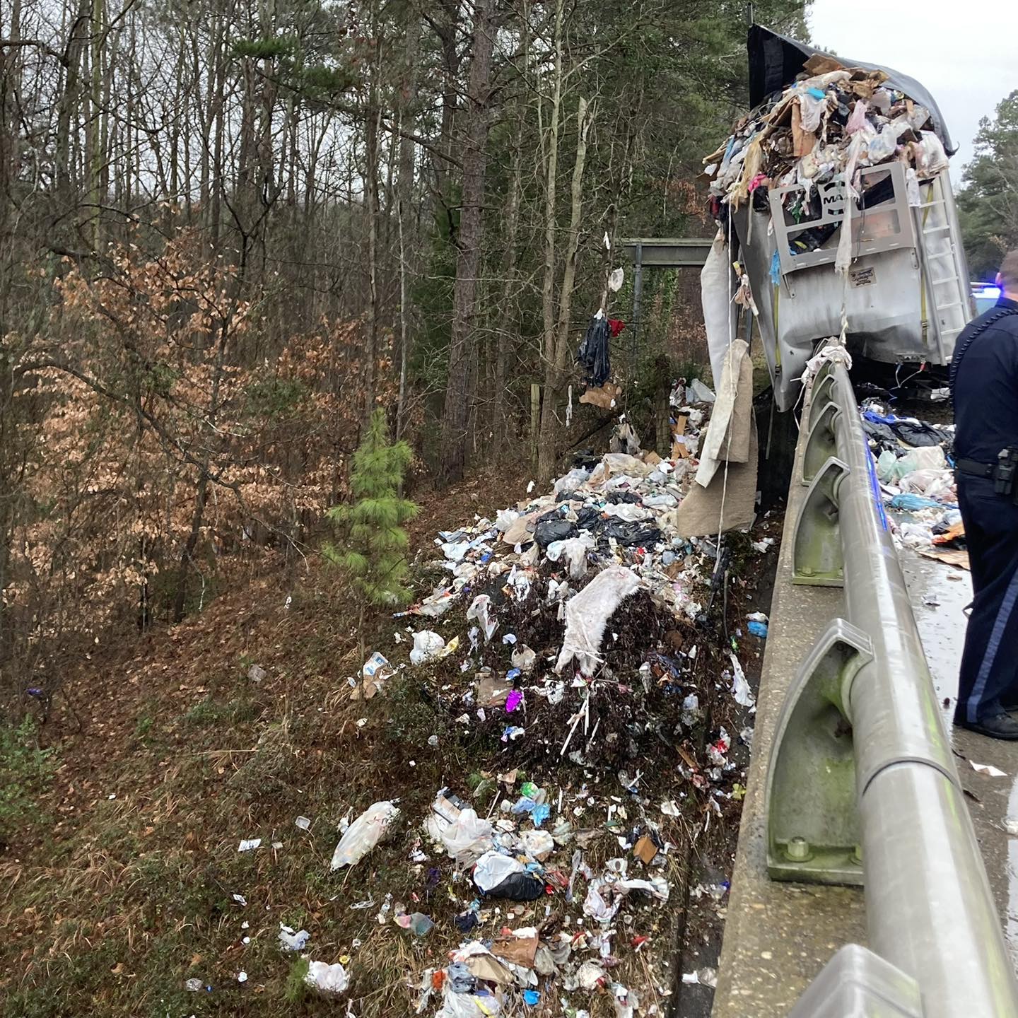 Trash can be seen on US 58 westbound at the Nansemond Parkway overpass in Suffolk after a trailer separated from the tractor.