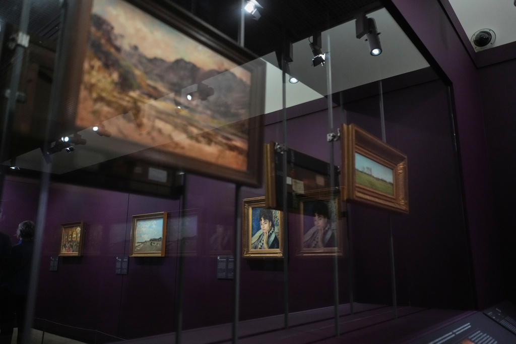 French painter Pierre-Auguste Renoir's painting titled Madame Alphonse Daudet, center, is on exhibit in the Musée d'Orsay museum's new permanent gallery dedicated to so-called MNR artworks, pieces recovered after World War II whose ownership remains uncertain, in Paris, Monday, May 4, 2026. 