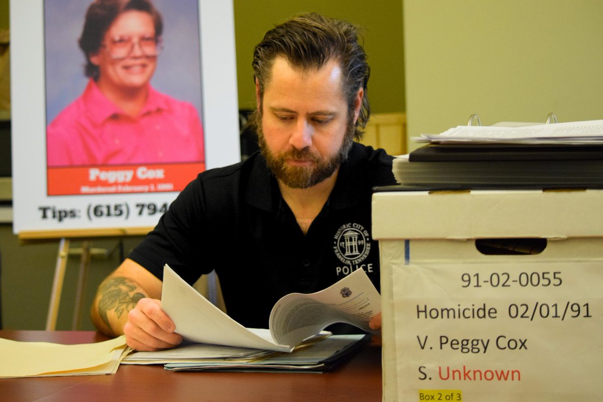 Detective Matt Thompson reviewing case files tied to Cox’s murder