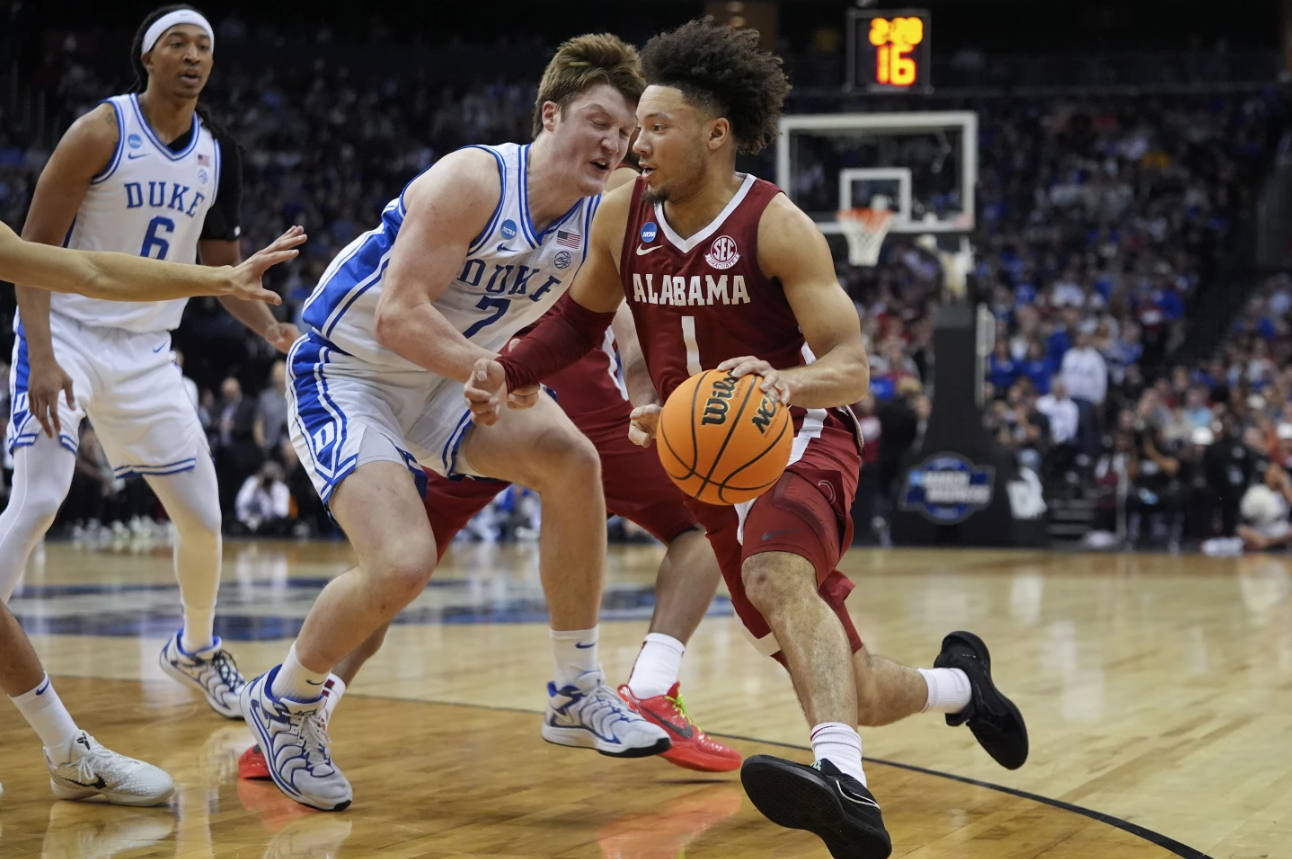 Alabama guard Mark Sears (1) drives against Duke guard Kon Knueppel (7) during the first half of an Elite Eight round NCAA college basketball tournament game, Saturday, March 29, 2025, in Newark, N.J.