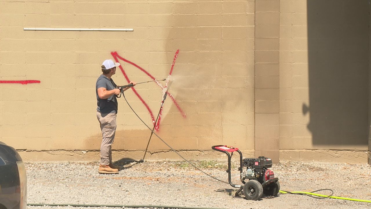 Jesus Worship Center church member cleaning  graffiti 
