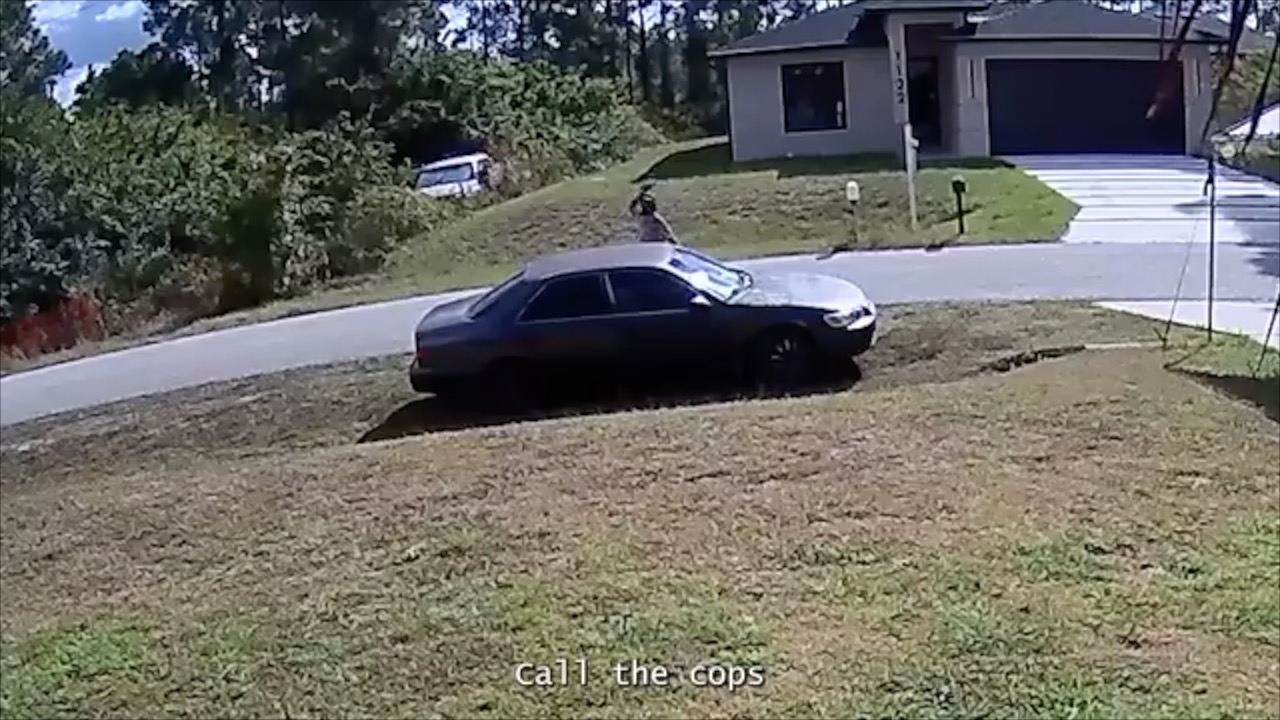 Man throws brick at car