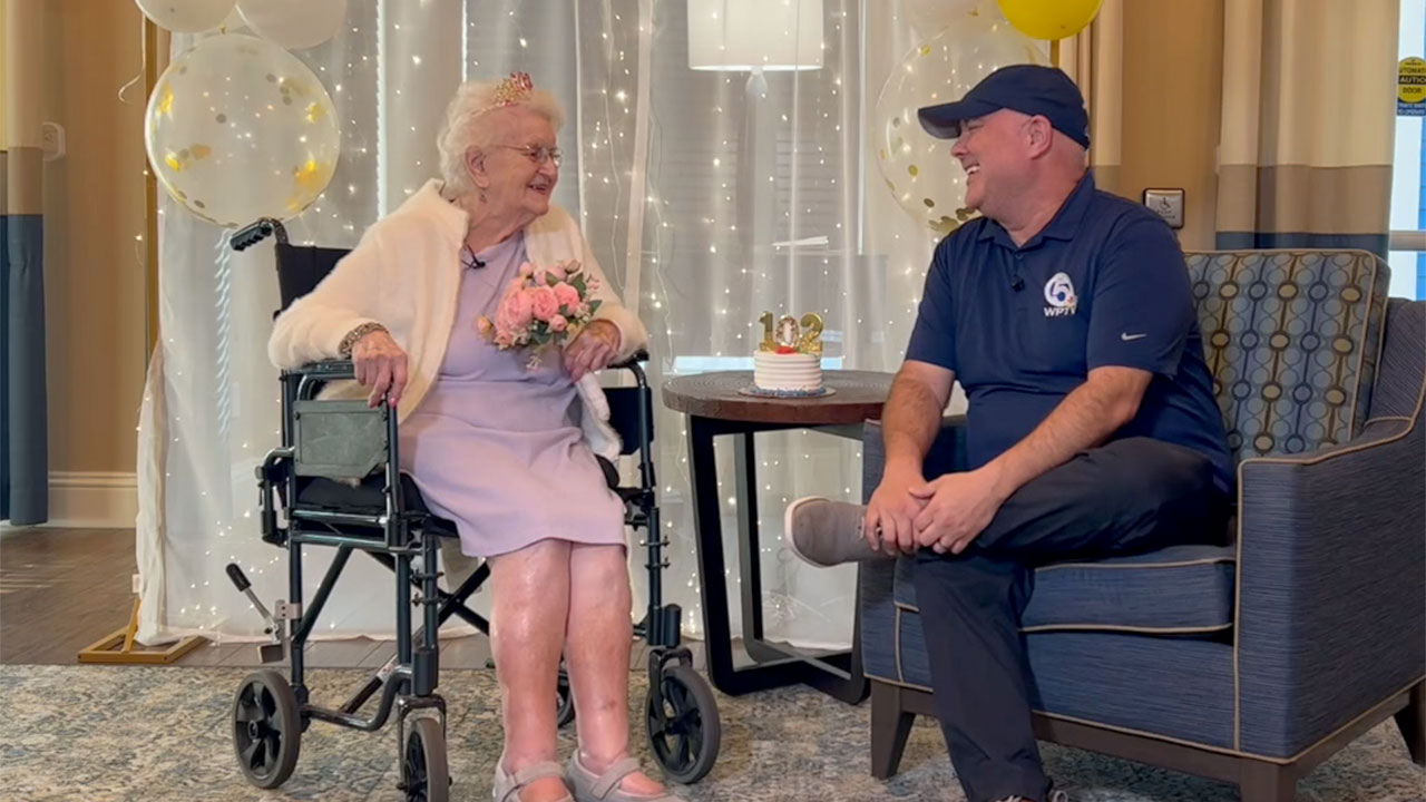 Ruth Whiteman speaks to WPTV reporter T.A. Walker while celebrating her 102nd birthday in Stuart. 