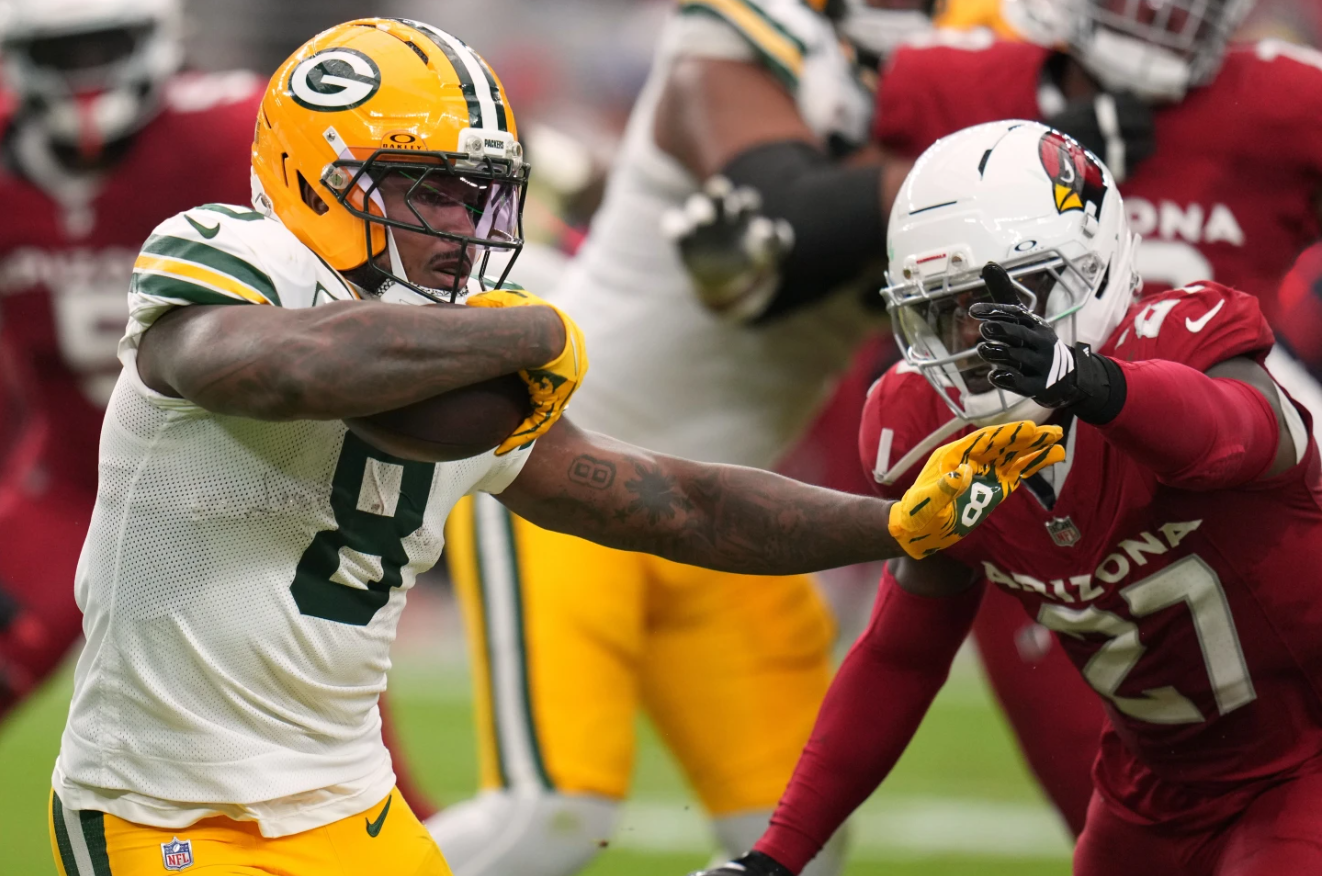 Green Bay Packers' Josh Jacobs tries to get past Arizona Cardinals Akeem Davis-Gaither during the second half of an NFL football game Sunday, Oct. 19, 2025, in Glendale, Ariz.