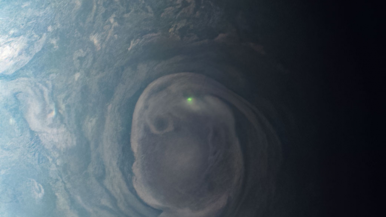 A green light is seen in a middle of a storm.