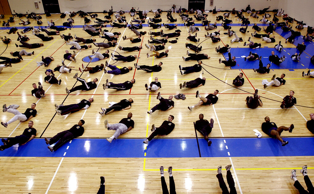 Air Force members take part in Physical Training exercises at the Fitness and Sports Center at Langley Air Force Base. 