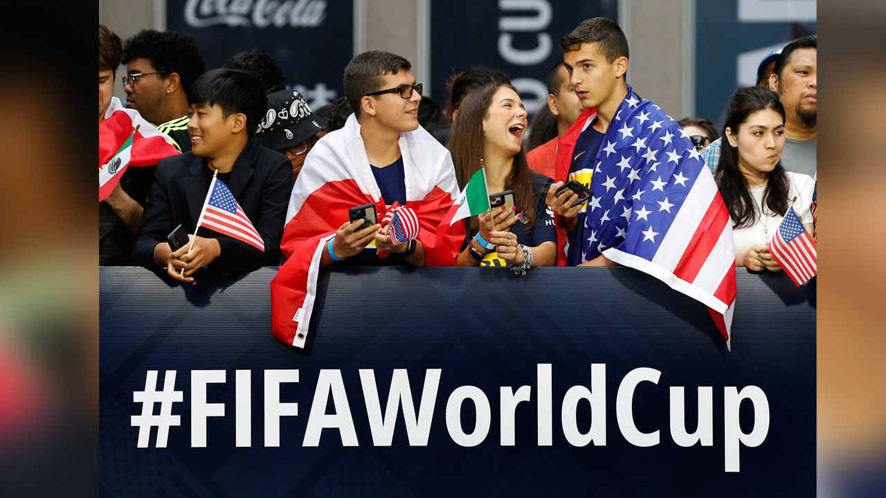 Fans wait along 6th Ave. for FIFA's announcement of the names of the host cities for the 2026 World Cup soccer tournament, Thursday, June 16, 2022, in New York.