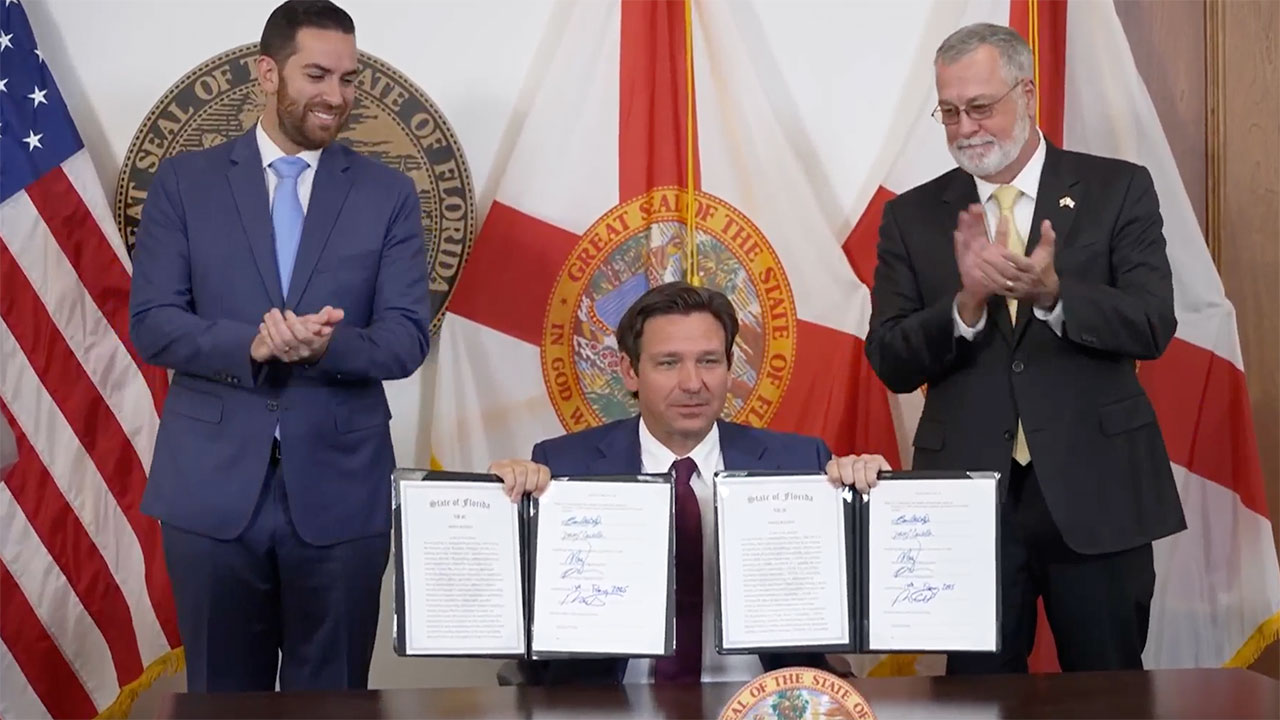 Gov. Ron DeSantis (center) signs new legislation on Feb. 13, 2025, to combat illegal immigration in Florida with Speaker of the House Danny Perez (left) and Sen. President Ben Albritton.