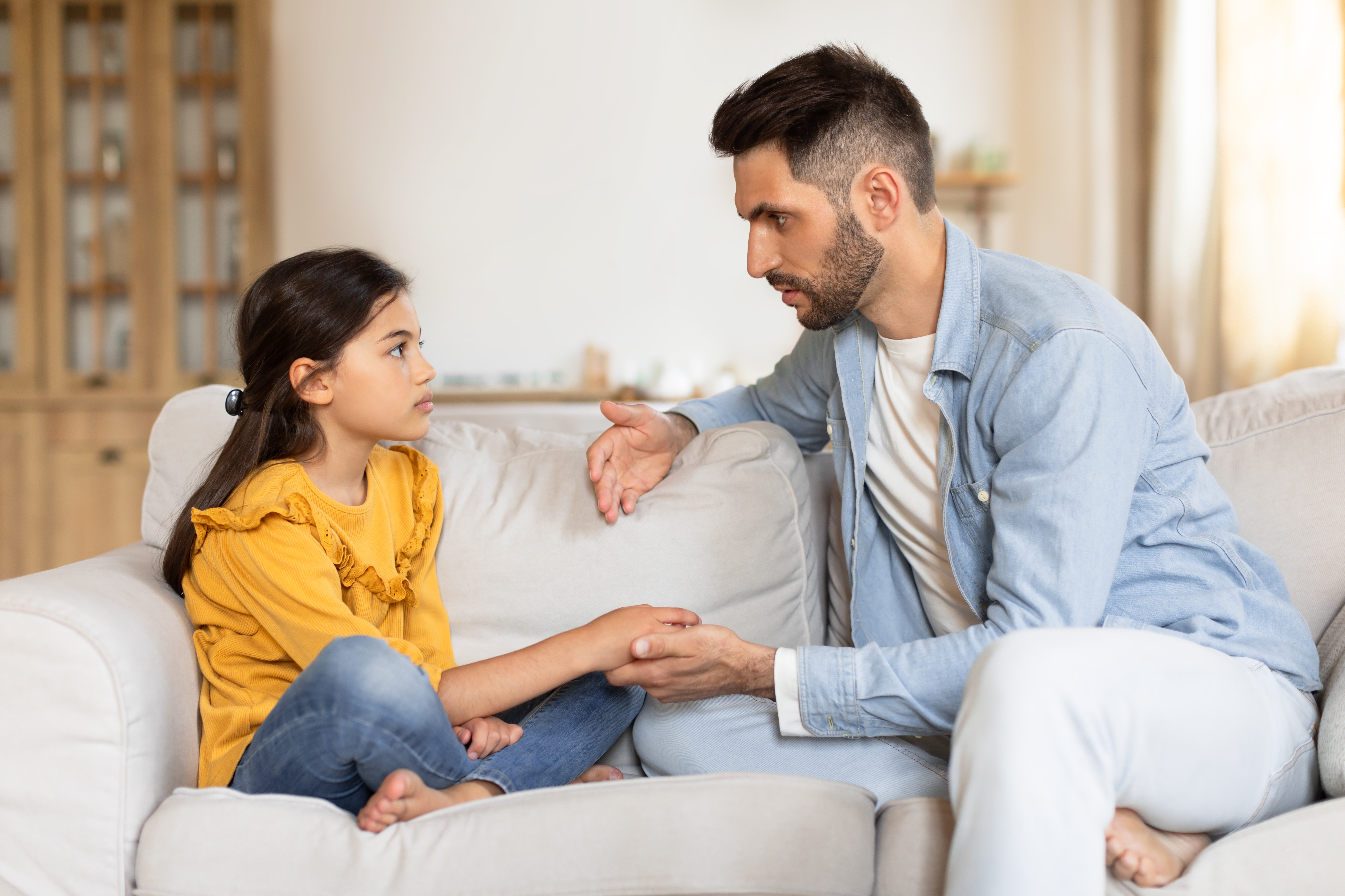 Father talking to his child about something serious.