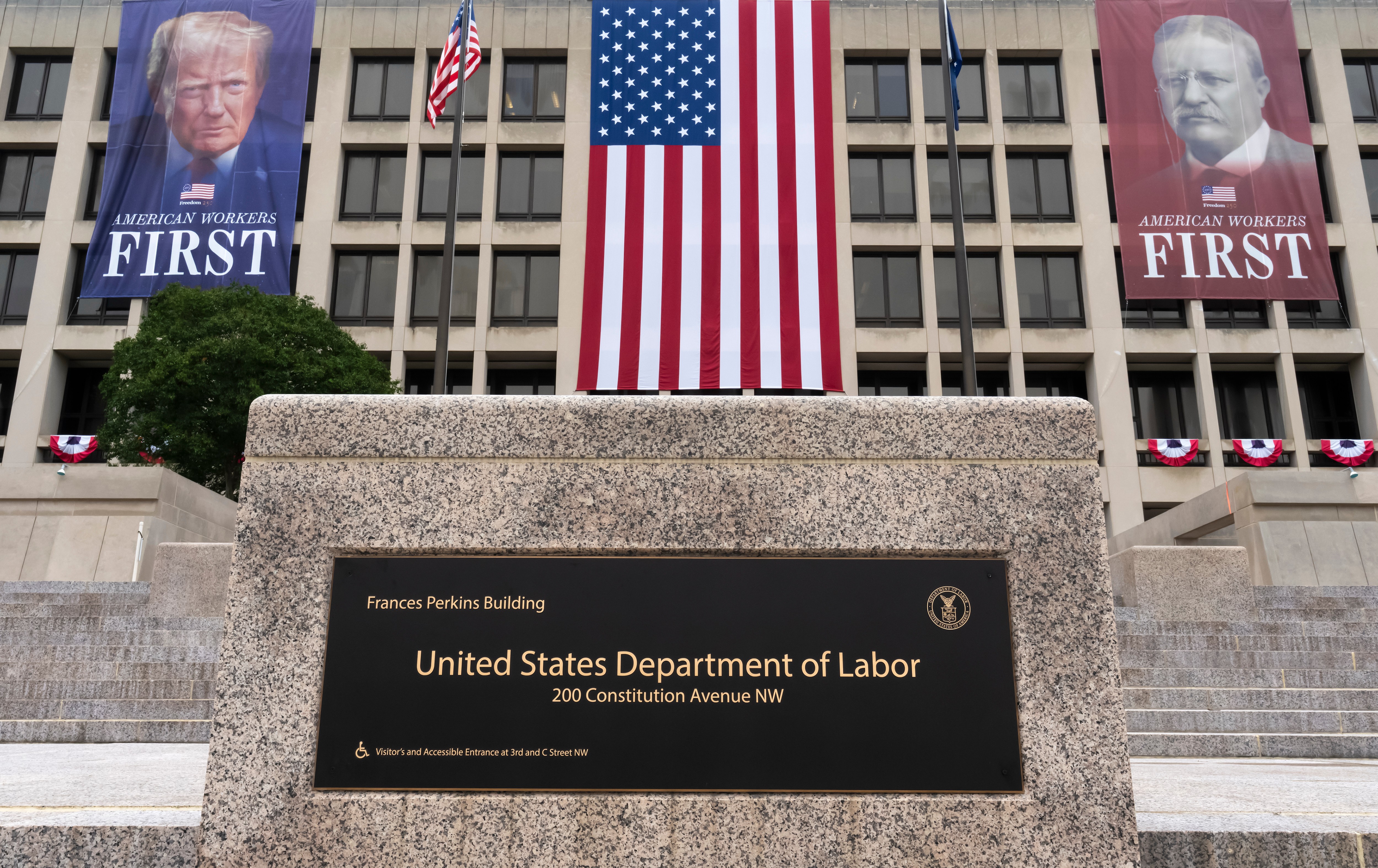 FILE - Portraits of Presidents Donald Trump and Theodore Roosevelt hang above the Department of Labor in Washington, July 7, 2026.