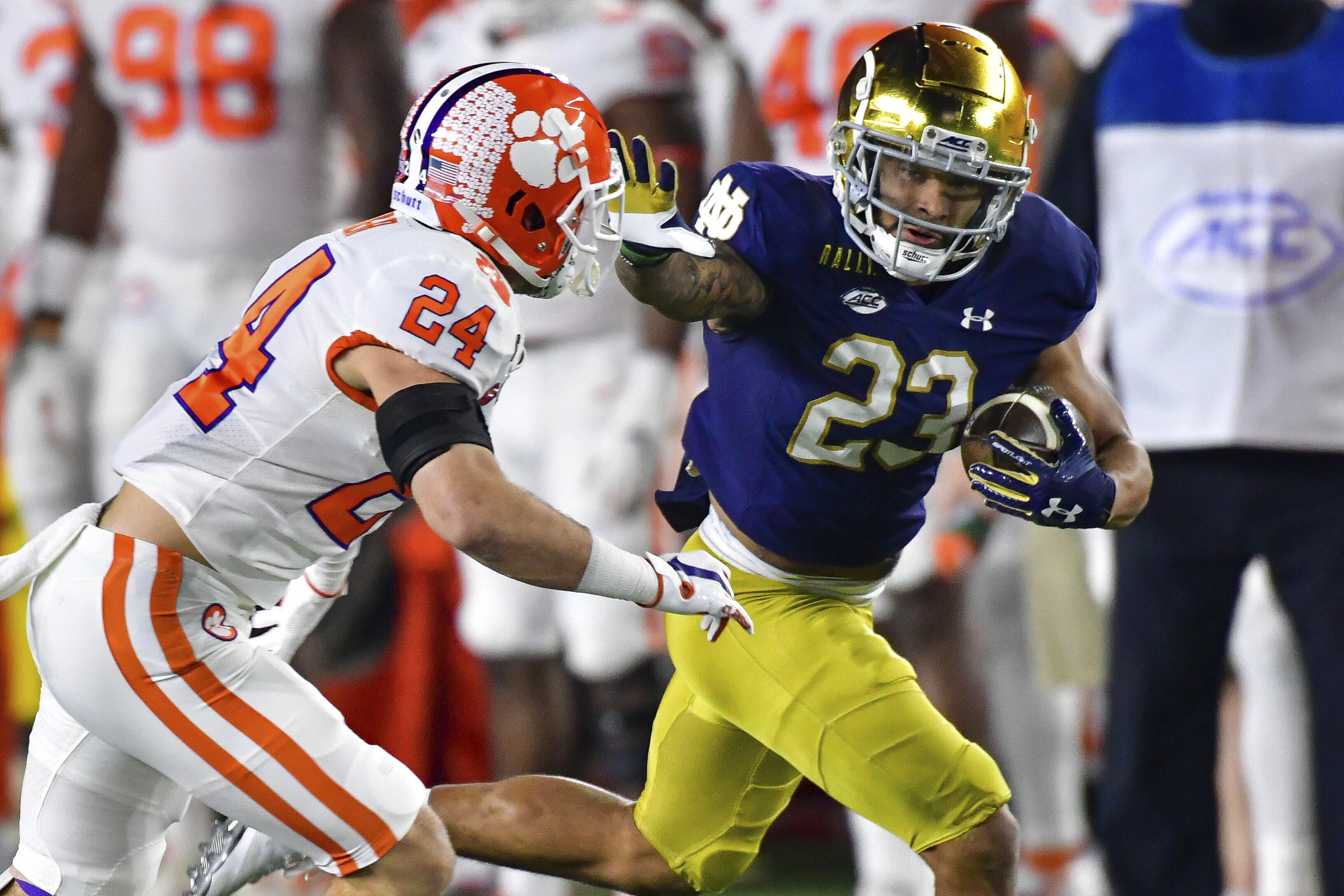Notre Dame running back Kyren Williams fends off Clemson Tigers safety Nolan Turner in 2020