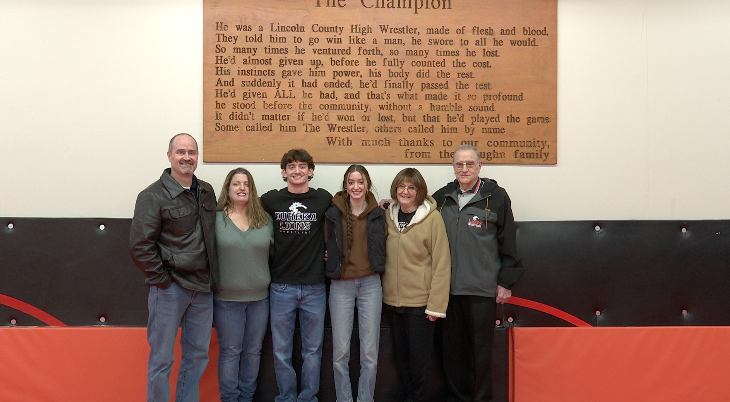 Timothy Schmidt and family in the Lincoln County High School wrestling room, Eureka