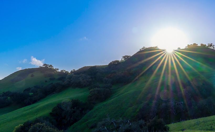 Sun peaking out over the hills near Cal Poly