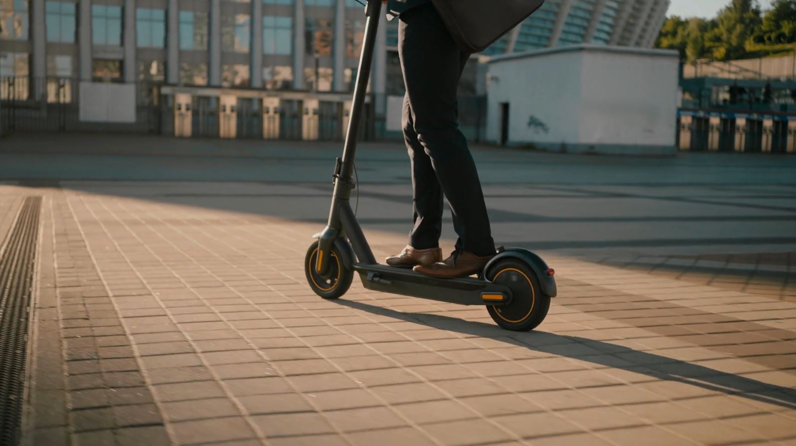man riding stand-up electric scooter e-scooter