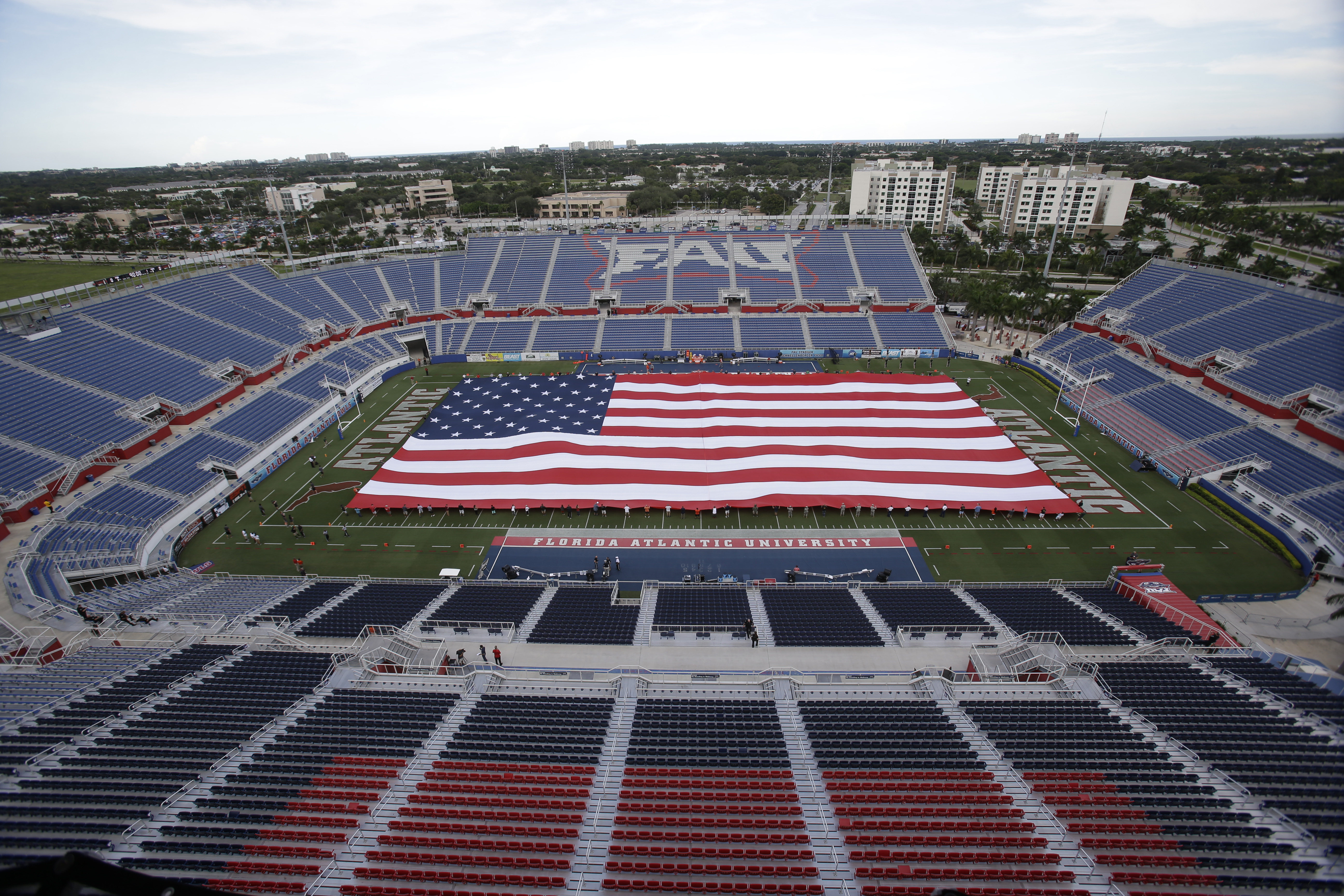 American flag draped across field at FAU Stadium before FAU Owls and Miami Hurricanes game in 2015