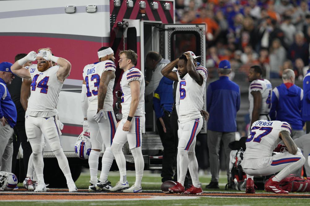 Buffalo Bills players react as teammate Damar Hamlin is examined during the first half of an NFL football game against the Cincinnati Bengals, Monday, Jan. 2, 2023, in Cincinnati. 
