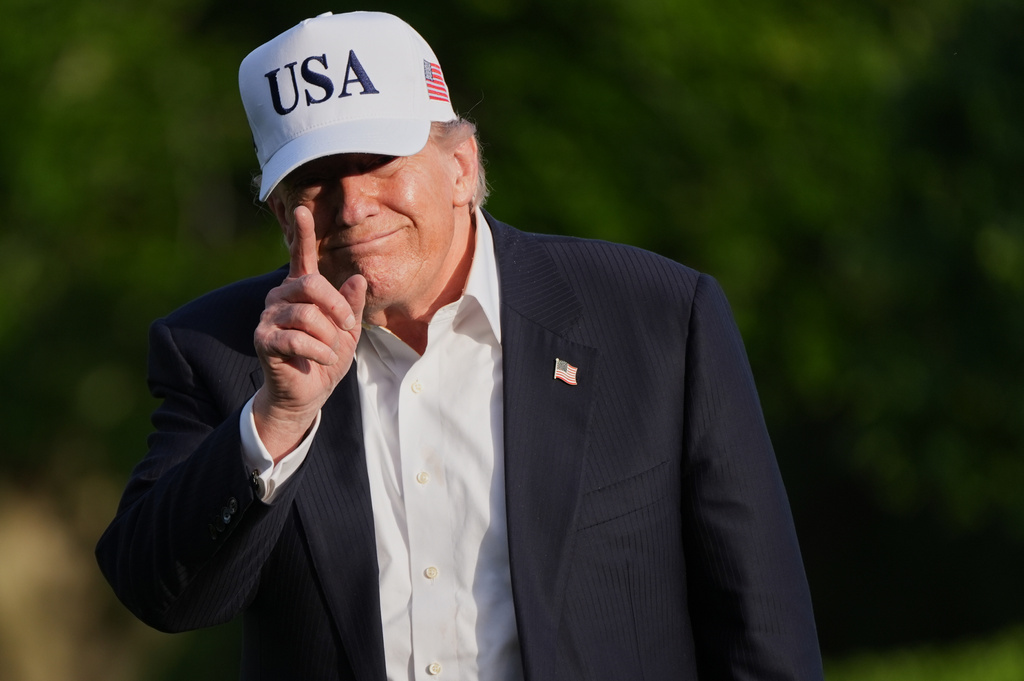 President Donald Trump gestures to reporters as he walks across the South Lawn of the White House, Friday, May 15, 2026, in Washington.