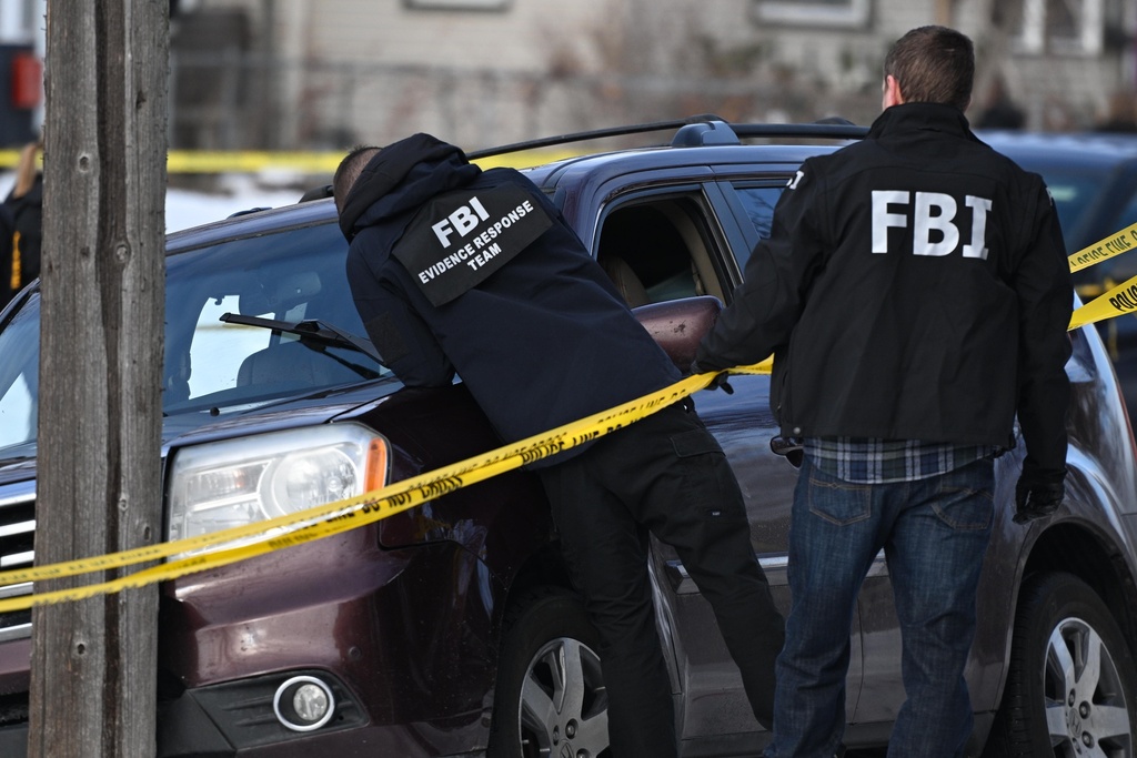 Law enforcement officers attend to the scene of the shooting involving federal law enforcement agents, Wednesday, Jan. 7, 2026, in Minneapolis. 