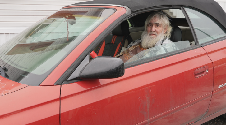 Man with disabilities sleeps in car