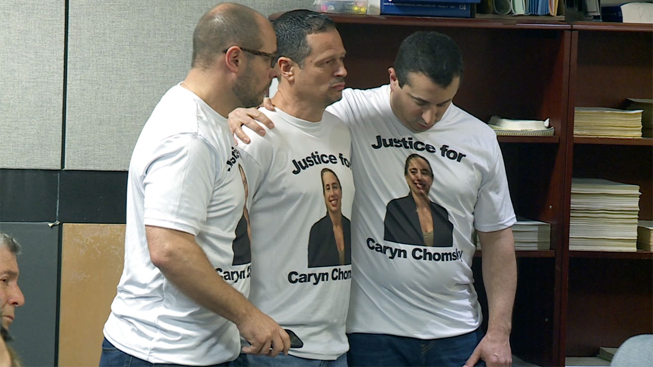 Ayal Chomsky is comforted by family members during the sentencing for Myles Scott after his wife, Caryn Chomsky, was killed in June 2024.